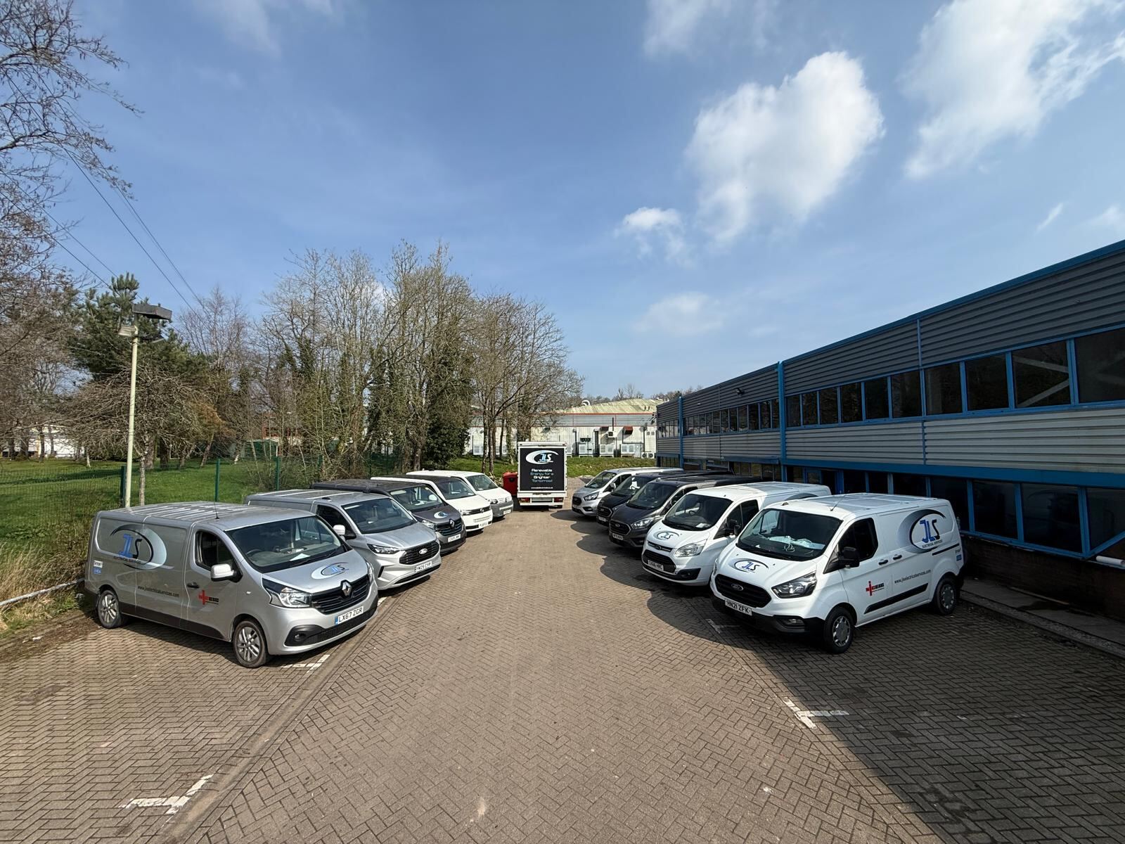 The JLS Electrical Services van fleet outside the company's unit at Llantrisant Business Park